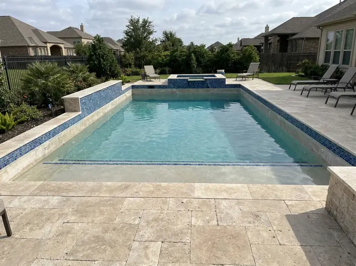 A bucket with a marked water line sitting on a pool step, demonstrating how to set up the bucket test for checking pool water loss.